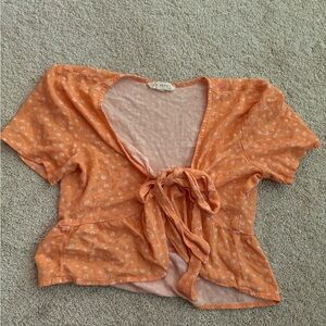 Orange flowy cropped tie top with white flowers